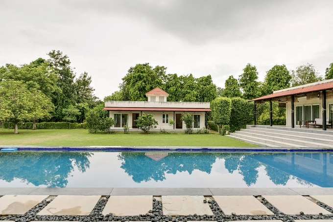 Exterior view of the property with lawn and swimming pool